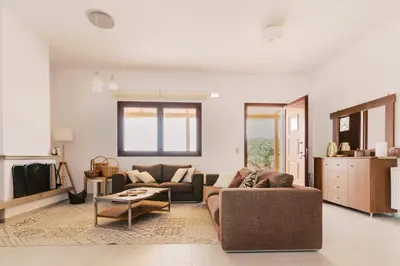 a living room with a couch and a table at Alonia View House in Asklipiḯon
