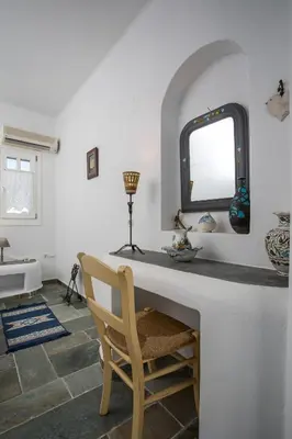 a room with a counter with a chair and a mirror at Traditional Greek Island Summer at Villa Julia in Kolimbia