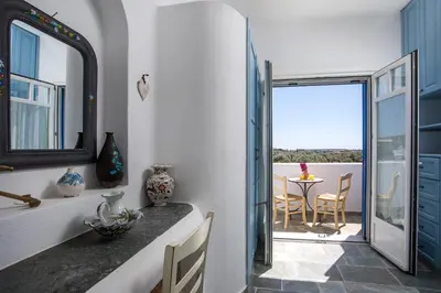 a kitchen with a view of a balcony with a table at Traditional Greek Island Summer at Villa Julia in Kolimbia