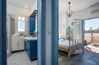 a blue and white bathroom with a bed and a sink at Traditional Greek Island Summer at Villa Julia in Kolimbia
