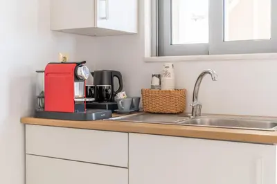 a kitchen counter with a coffee maker on it at Alpha Urban Suites in Rhodes Town