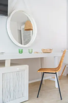 a white desk with a mirror and a chair at Alpha Urban Suites in Rhodes Town