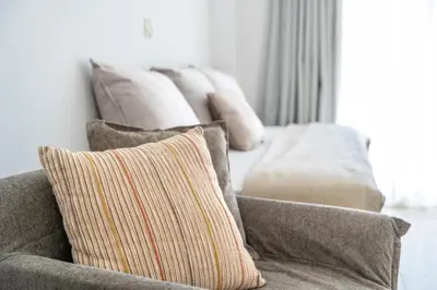 a row of pillows on a couch in a living room at Alpha Urban Suites in Rhodes Town