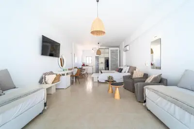 a living room with white walls and white furniture at Alpha Urban Suites in Rhodes Town