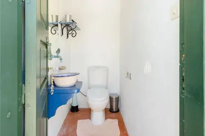 a bathroom with a toilet and a sink at Los Olivos V.I.P Poolvilla Kritinia in Kamiros