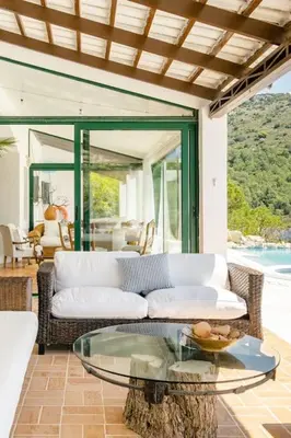 a living room with a couch and a glass table at Los Olivos V.I.P Poolvilla Kritinia in Kamiros