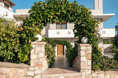 a gate to a building with areath of flowers at Vista Magica in Pastida