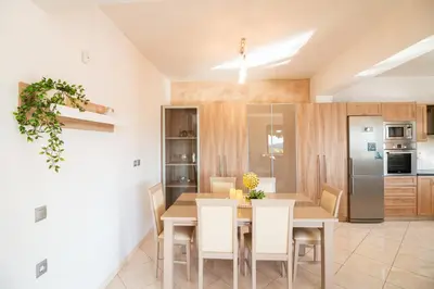 a kitchen and dining room with a table and chairs at Vista Magica in Pastida