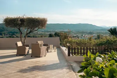 a patio with chairs and a view of a city at Vista Magica in Pastida