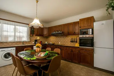 a kitchen with a table and a white refrigerator at Luciana City Apartment in Rhodes Town