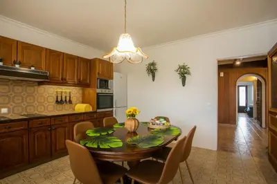 a kitchen with a table with chairs and a dining room at Luciana City Apartment in Rhodes Town