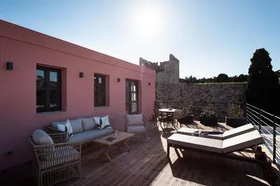 a patio with a couch and chairs on a deck at Fluvian Terrace in Rhodes Town