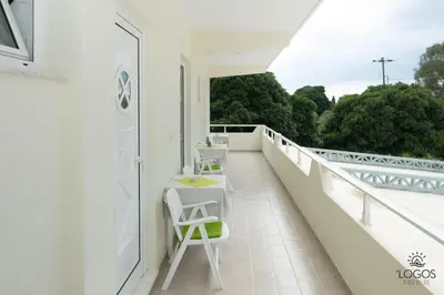 a balcony with two chairs and a table on it at Let it Be Apartments in Theologos