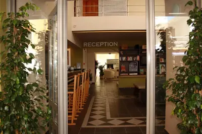 a view of the entrance to a restaurant with plants at Svea Hotel in Rhodes Town