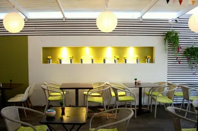 a dining room with tables and chairs and lights at Svea Hotel in Rhodes Town