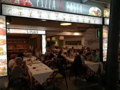 a group of people sitting at tables in a restaurant at Svea Hotel in Rhodes Town