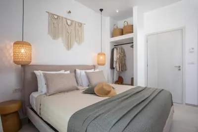 a bedroom with a bed with a hat on it at Villa Elaia in Afantou