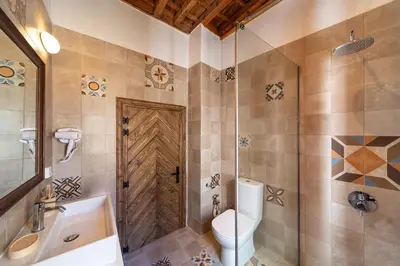 a bathroom with a toilet and a shower and a sink at Rodos Old Town Aqua Luxury House in Rhodes Town