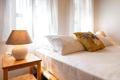 a bedroom with a bed with a lamp on a table at Rodos Old Town Aqua Luxury House in Rhodes Town