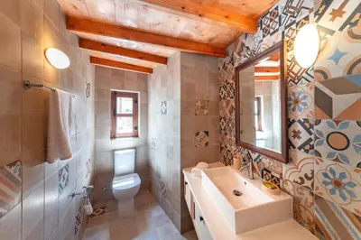 a bathroom with a sink and a toilet and a mirror at Rodos Old Town Aqua Luxury House in Rhodes Town