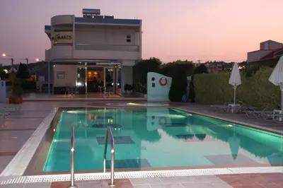 a swimming pool in front of a building at Sun Maris in Faliraki