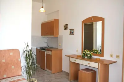 a kitchen with a sink and a counter with a mirror at Sun Maris in Faliraki