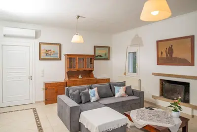 a living room with a couch and a fireplace at Pines Villa in Rhodes Town