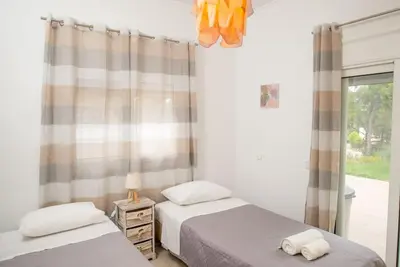 two twin beds in a bedroom with a window at Pines Villa in Rhodes Town