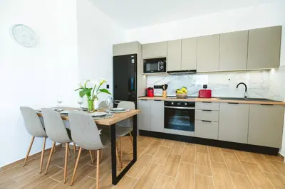 a kitchen with a table and chairs in a room at Casa Zoe Luxurious Retreat in Archangelos