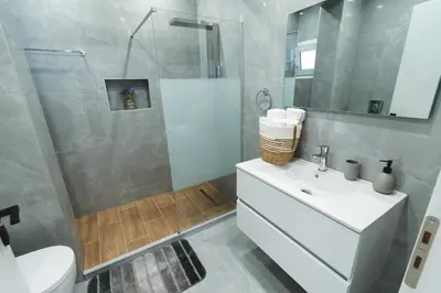 a bathroom with a toilet and a sink and a shower at Casa Zoe Luxurious Retreat in Archangelos