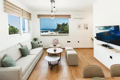 a living room with a couch and a table at Casa Zoe Luxurious Retreat in Archangelos