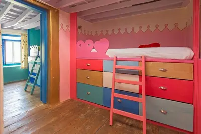 a kids room with a bunk bed and a ladder at TheDreamHouse ChlorineFree Heated pool Artvillage in Koskinou