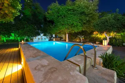 a swimming pool in a backyard at night at TheDreamHouse ChlorineFree Heated pool Artvillage in Koskinou