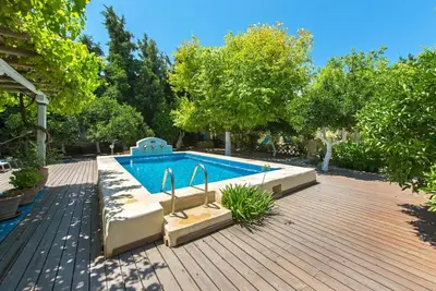 a swimming pool in the middle of a yard at TheDreamHouse ChlorineFree Heated pool Artvillage in Koskinou