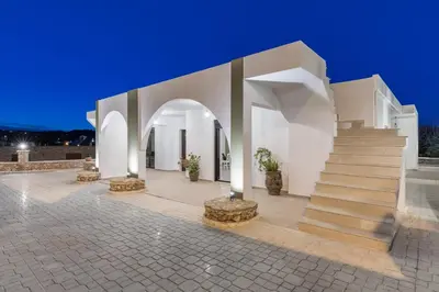 a white building with a staircase and a stair case at Casa Arches, Rhodes in Archipolis