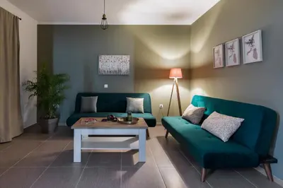 a living room with a blue couch and a table at Casa Arches, Rhodes in Archipolis