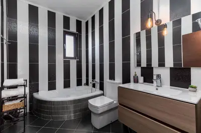 a bathroom with a tub and a toilet and a sink at Casa Arches, Rhodes in Archipolis