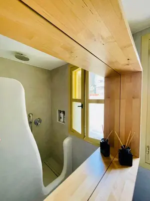 a room with a wooden floor and a window at Aegli Apartments Deluxe in Symi