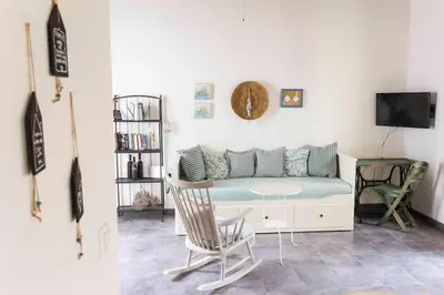 a living room with a couch and a table at Aegli Apartments Deluxe in Symi