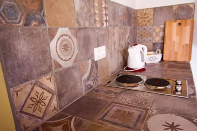a kitchen with a counter top with a stove at Aegli Apartments Deluxe in Symi