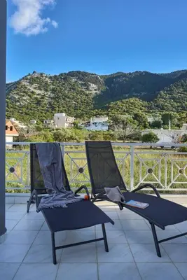 a pair of chairs sitting on top of a balcony at Chrysanthi Luxury Villa In Salakos, with Pool & Jacuzzi, Near Beach in Sálakos