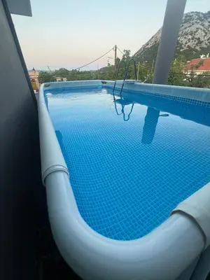 a blue swimming pool with a view of a mountain at Chrysanthi Luxury Villa In Salakos, with Pool & Jacuzzi, Near Beach in Sálakos