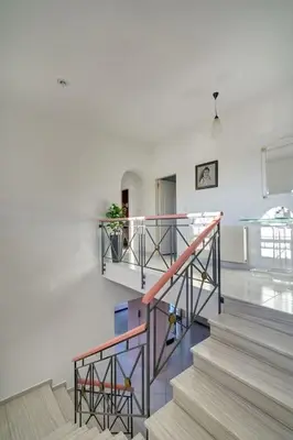 a staircase in a building with a stair case at Chrysanthi Luxury Villa In Salakos, with Pool & Jacuzzi, Near Beach in Sálakos