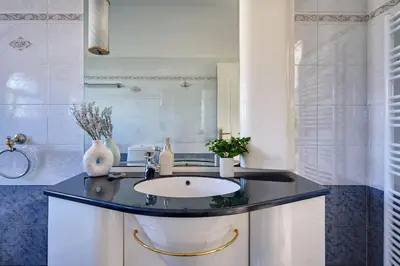 a bathroom with a sink and a mirror at Chrysanthi Luxury Villa In Salakos, with Pool & Jacuzzi, Near Beach in Sálakos