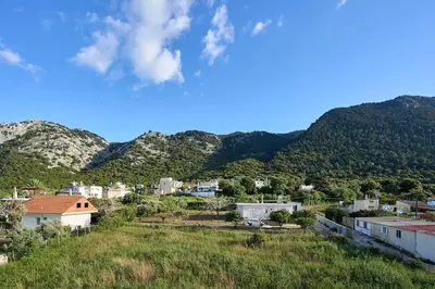 a view of a town with mountains in the background at Chrysanthi Luxury Villa In Salakos, with Pool & Jacuzzi, Near Beach in Sálakos