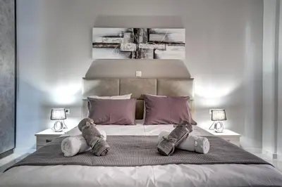 a bedroom with two teddy bears sitting on a bed at Sea & Joy House in Ialyssos
