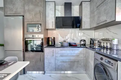a kitchen with stainless steel cabinets and a dishwasher at Sea & Joy House in Ialyssos