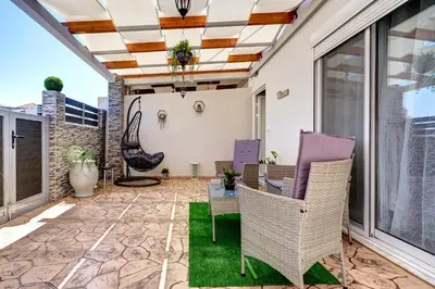 a patio with a table and chairs on it at Sea & Joy House in Ialyssos