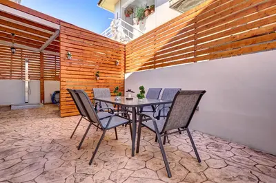a dining room with a table and chairs on a patio at Sea & Joy House in Ialyssos