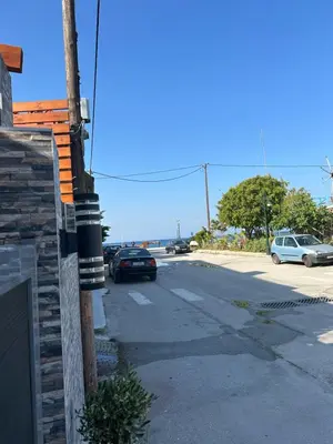 a street with cars parked on the side of a building at Sea & Joy House in Ialyssos
